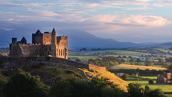 Landscape image show castle in Ireland that you can see on a Brendan Vacations guided tour. The castle is set atop a hill overlooking the valley below.