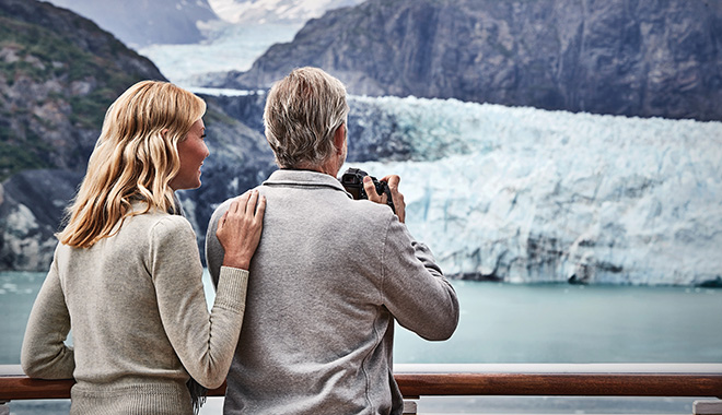 Mature couple on deck of Princess Cruise ship, viewing the winter scenery of Alaska.