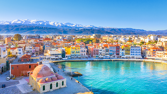 View of the water and buildings along the shore of Crete, Greece.