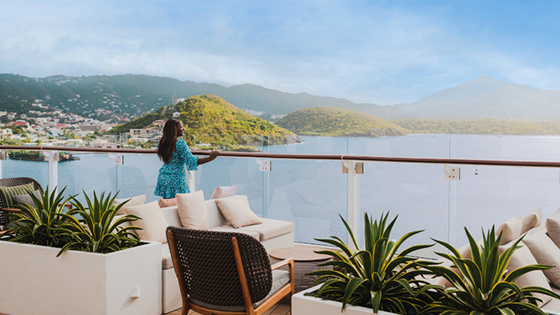 Woman looking off balcony into the ocean in St. Thomas.