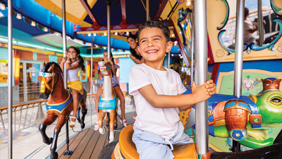 Little boy on the carousel on a Royal Caribbean cruise ship.